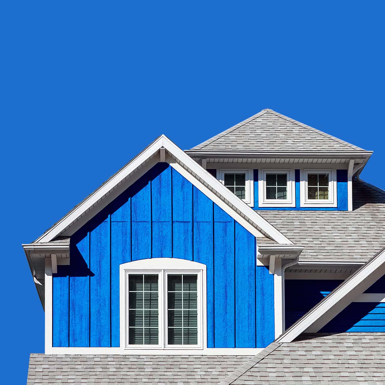 Roof of Florida house with blue sidings and white windows